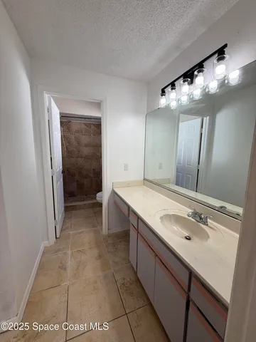 a bathroom with a sink a mirror and a shower