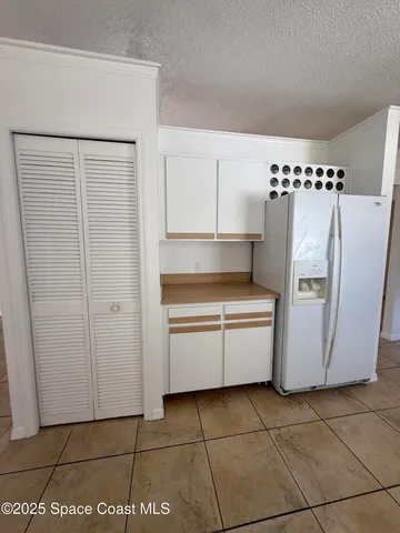 a room with a stove and a refrigerator