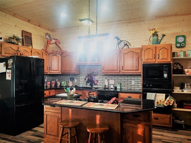 a kitchen with stainless steel appliances granite countertop a sink and cabinets