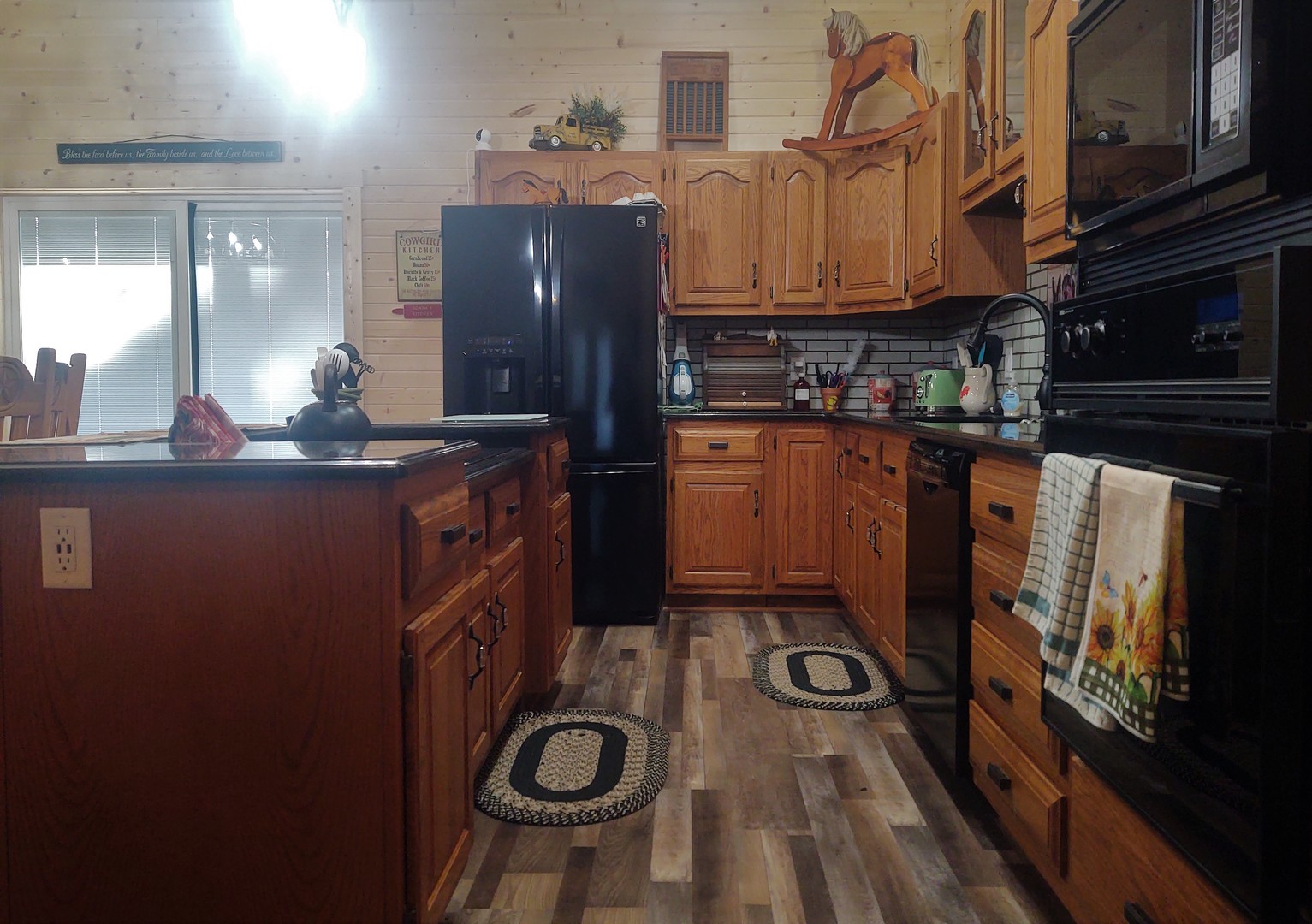 377 Lusk Road Golconda, IL 62938 - Photo 8 of 42 a kitchen with stainless steel appliances granite countertop a sink a stove and a wooden floors