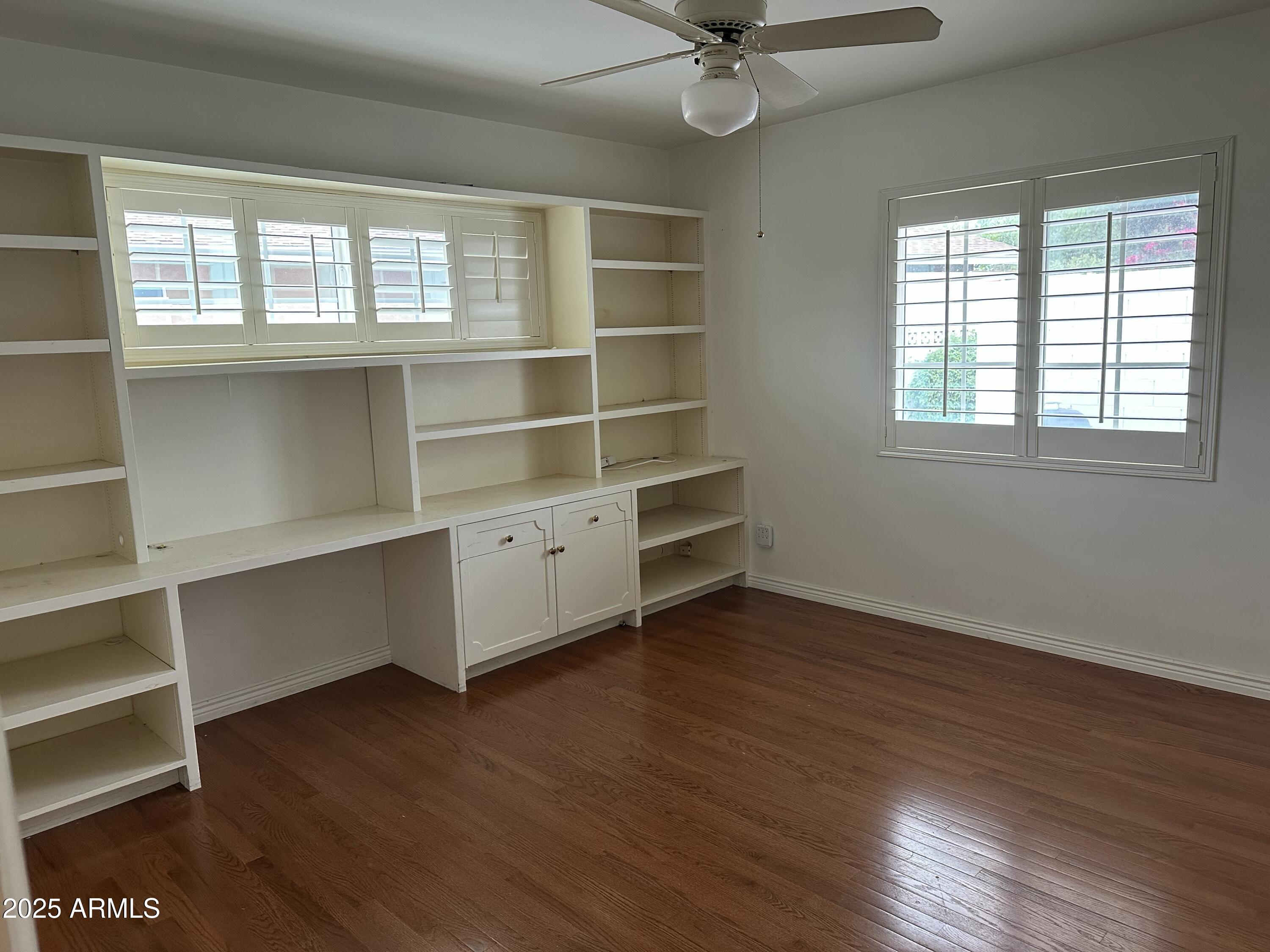 511 West Ocotillo Road Phoenix, AZ 85013 - Photo 12 of 14 a view of an empty room with a window and wooden floor