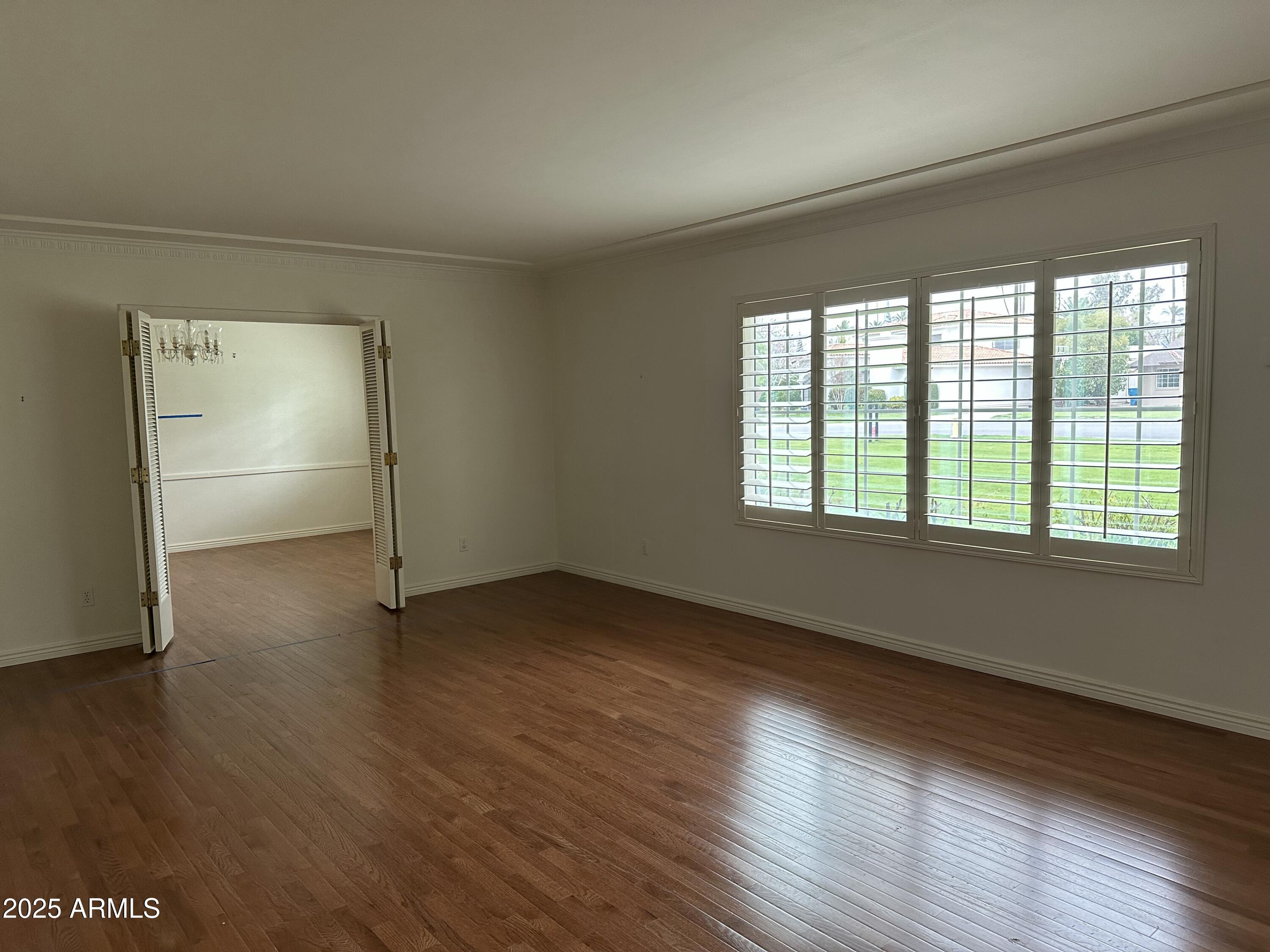 511 West Ocotillo Road Phoenix, AZ 85013 - Photo 3 of 14 an empty room with wooden floor cabinet and windows