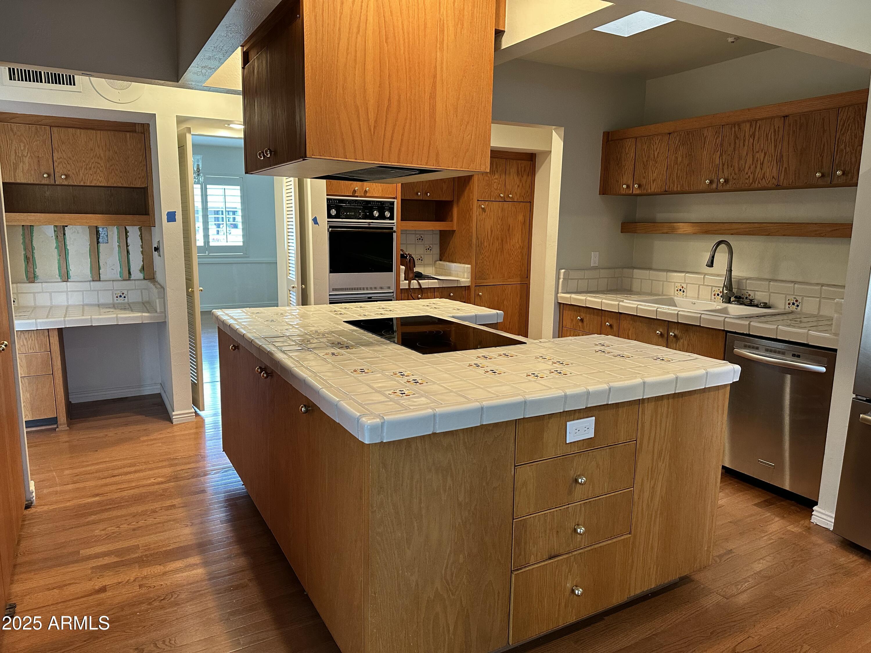 511 West Ocotillo Road Phoenix, AZ 85013 - Photo 5 of 14 a kitchen with kitchen island granite countertop a sink stove and cabinets