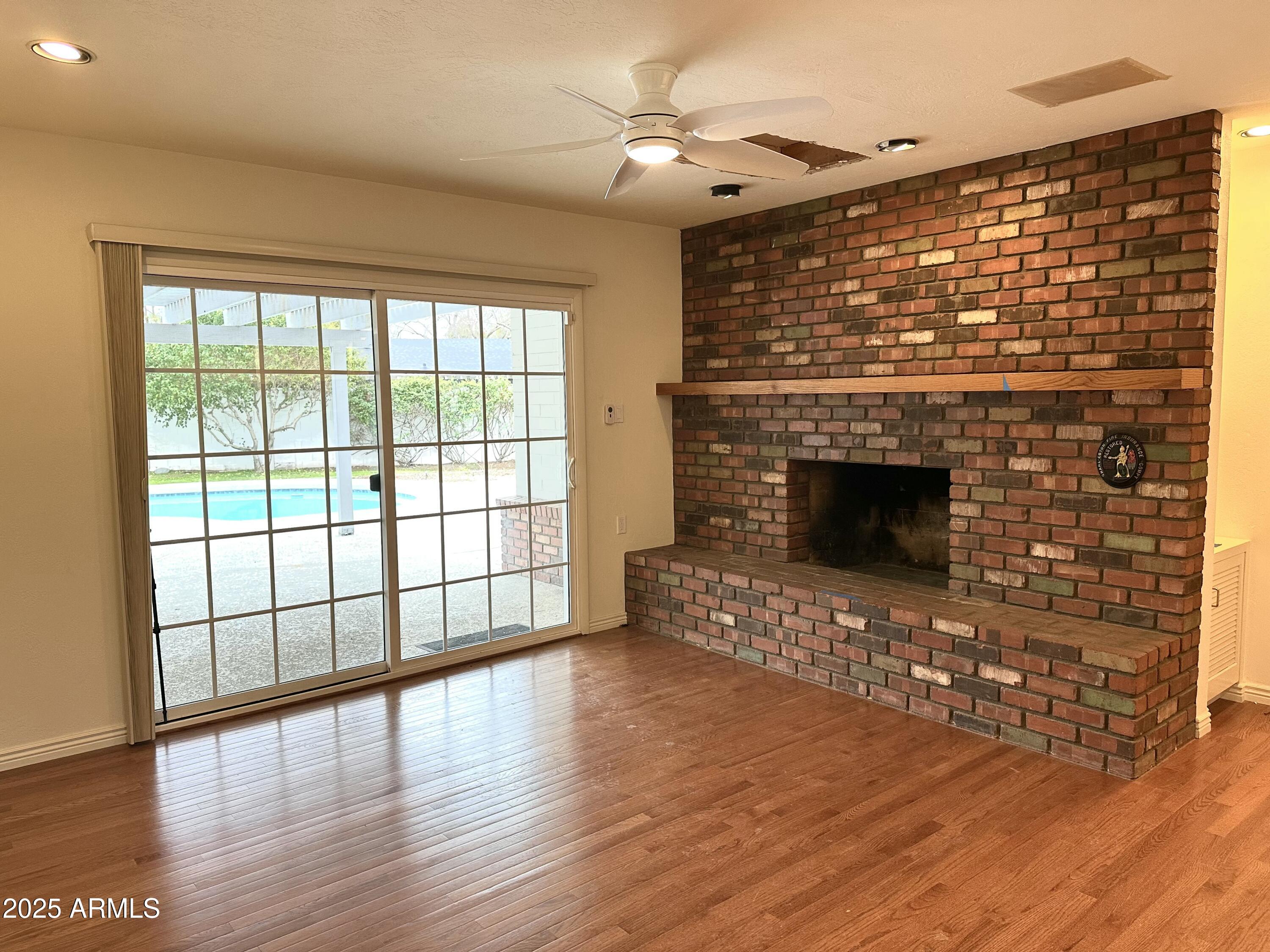 511 West Ocotillo Road Phoenix, AZ 85013 - Photo 6 of 14 a living room with furniture a fireplace and wooden floor
