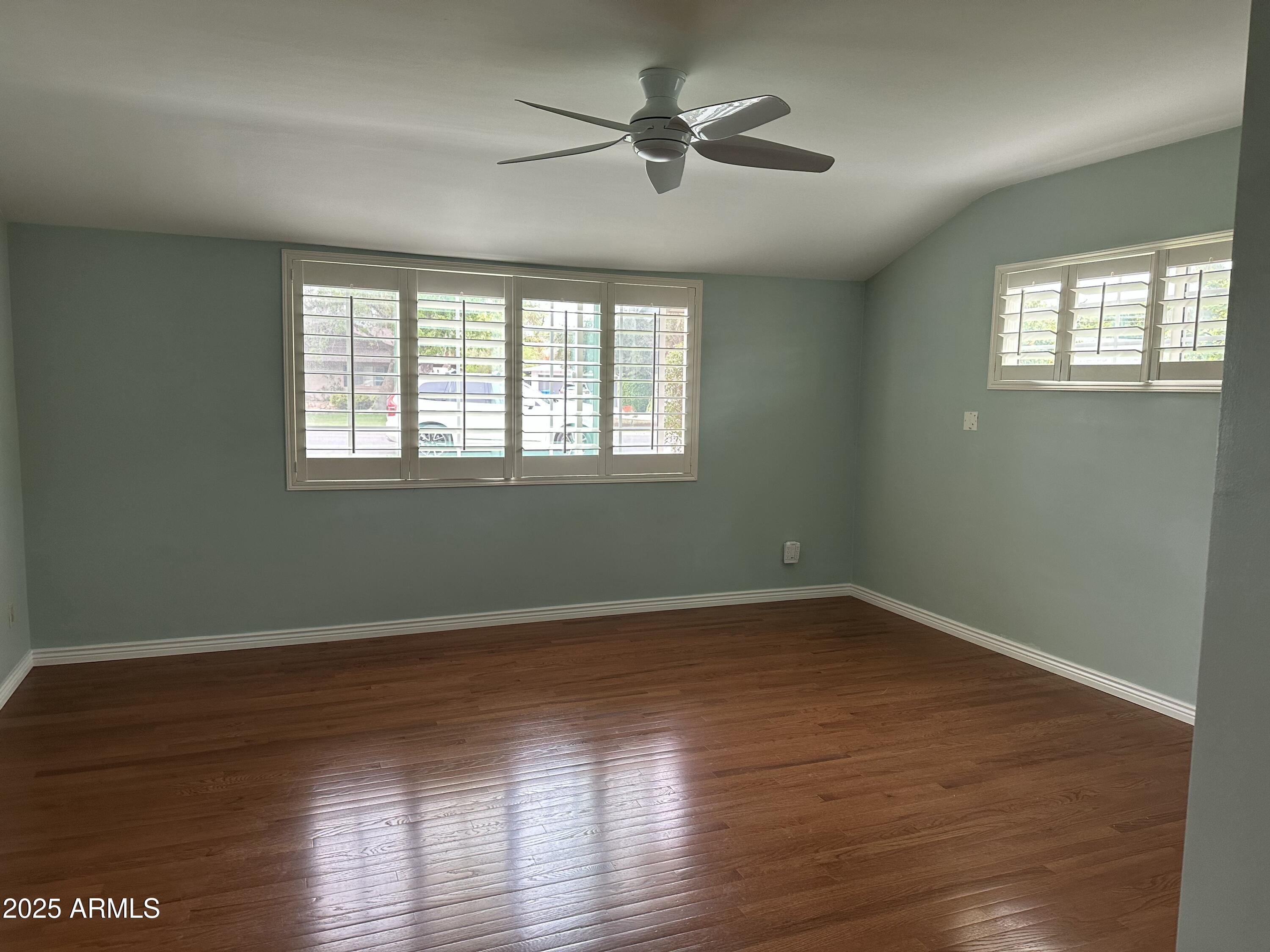 511 West Ocotillo Road Phoenix, AZ 85013 - Photo 9 of 14 a view of an empty room with wooden floor and a window