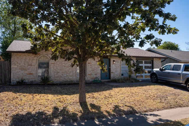 a front view of a house with parking space