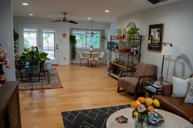 a living room with furniture and wooden floor