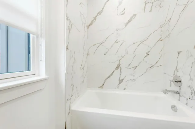 a bathroom with a toilet a sink and a window