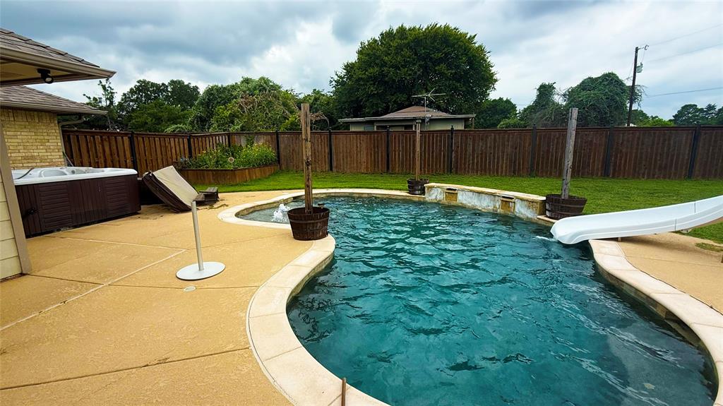 1356 Kerry Lane Azle, TX 76020 - Photo 22 of 27 Kidney-shaped inground pool featuring a white slide and integrated water features