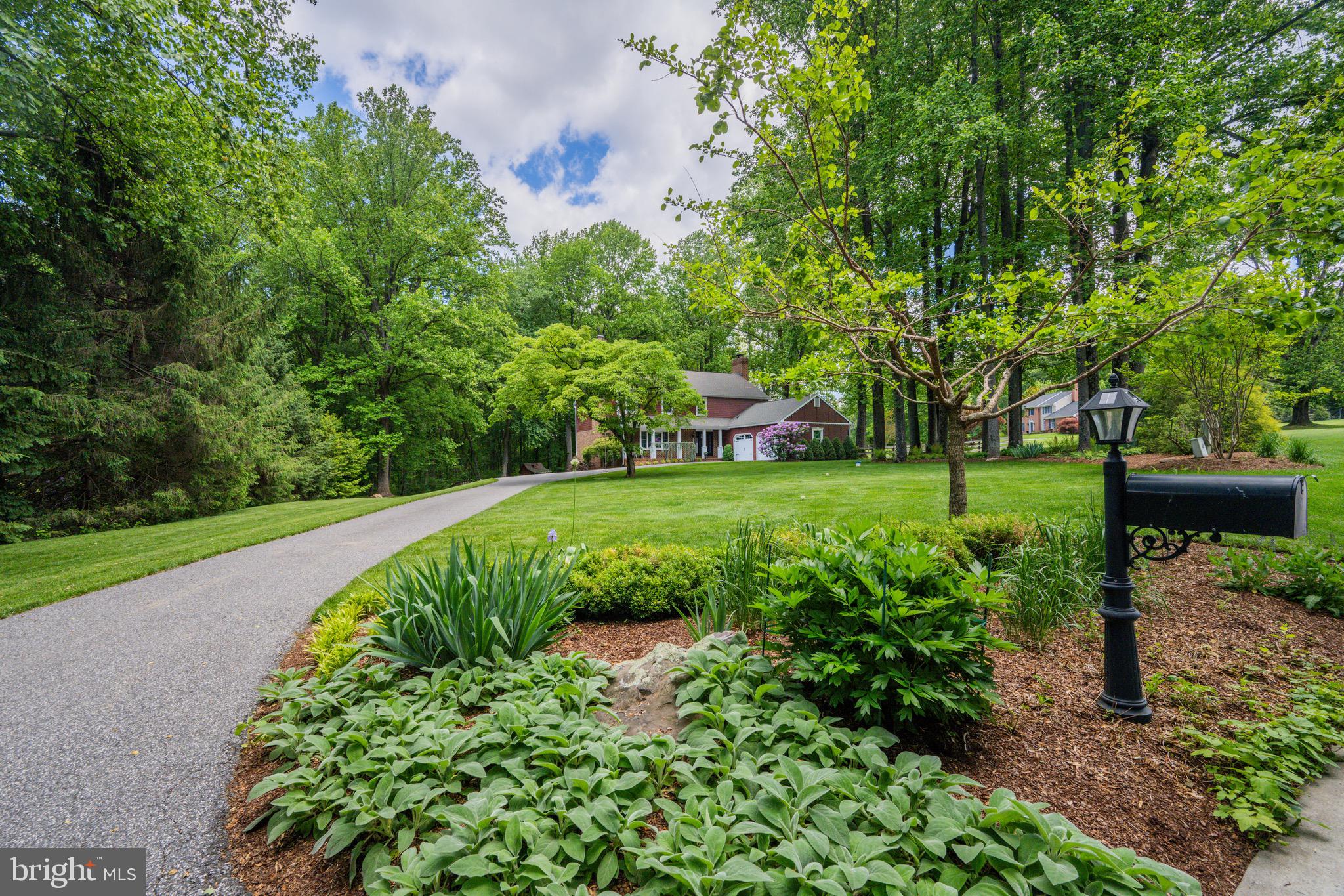 2 Wetherbee Court Phoenix, MD 21131 - Photo 2 of 19 a view of a garden with a bench