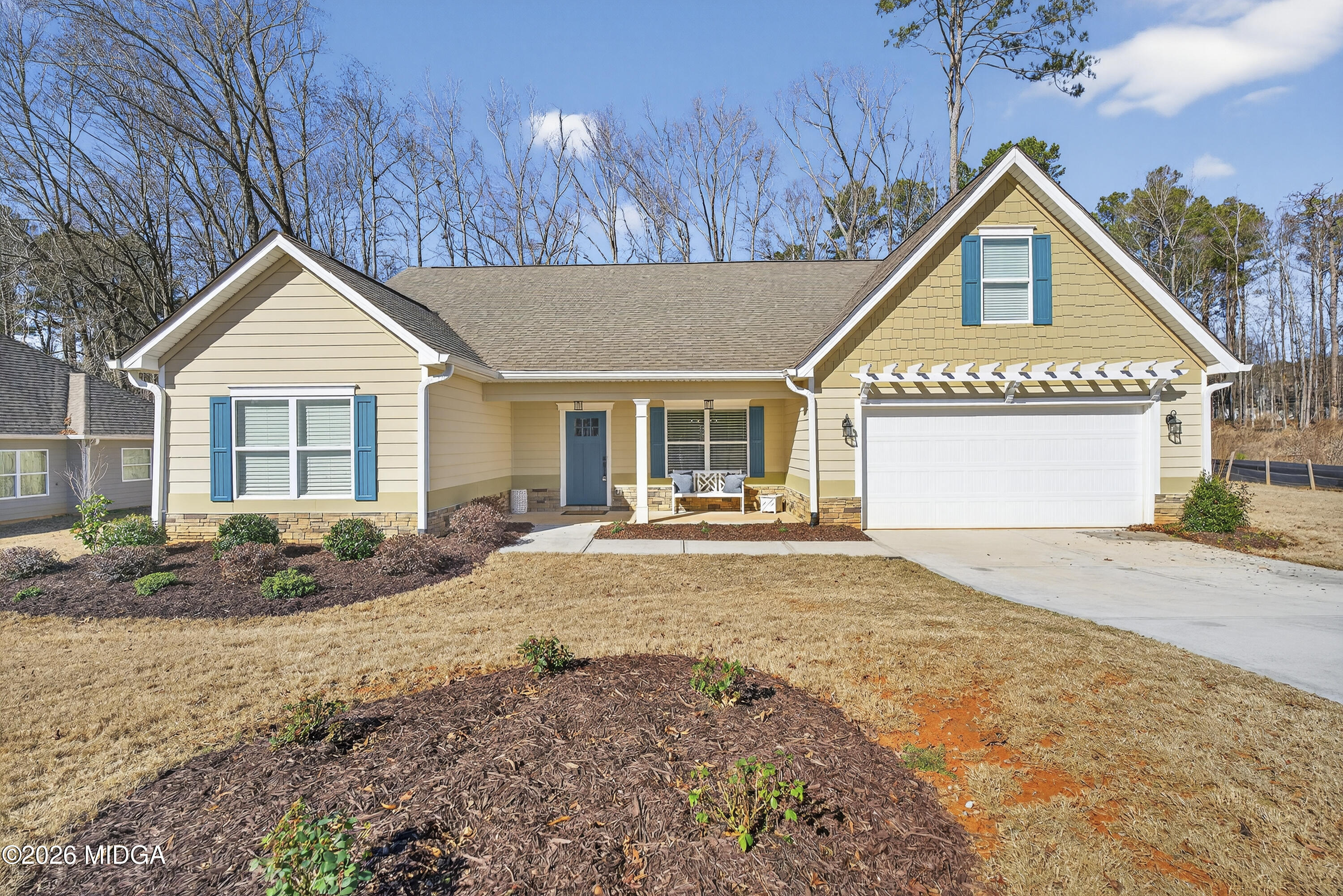 a front view of a house with a yard and garage