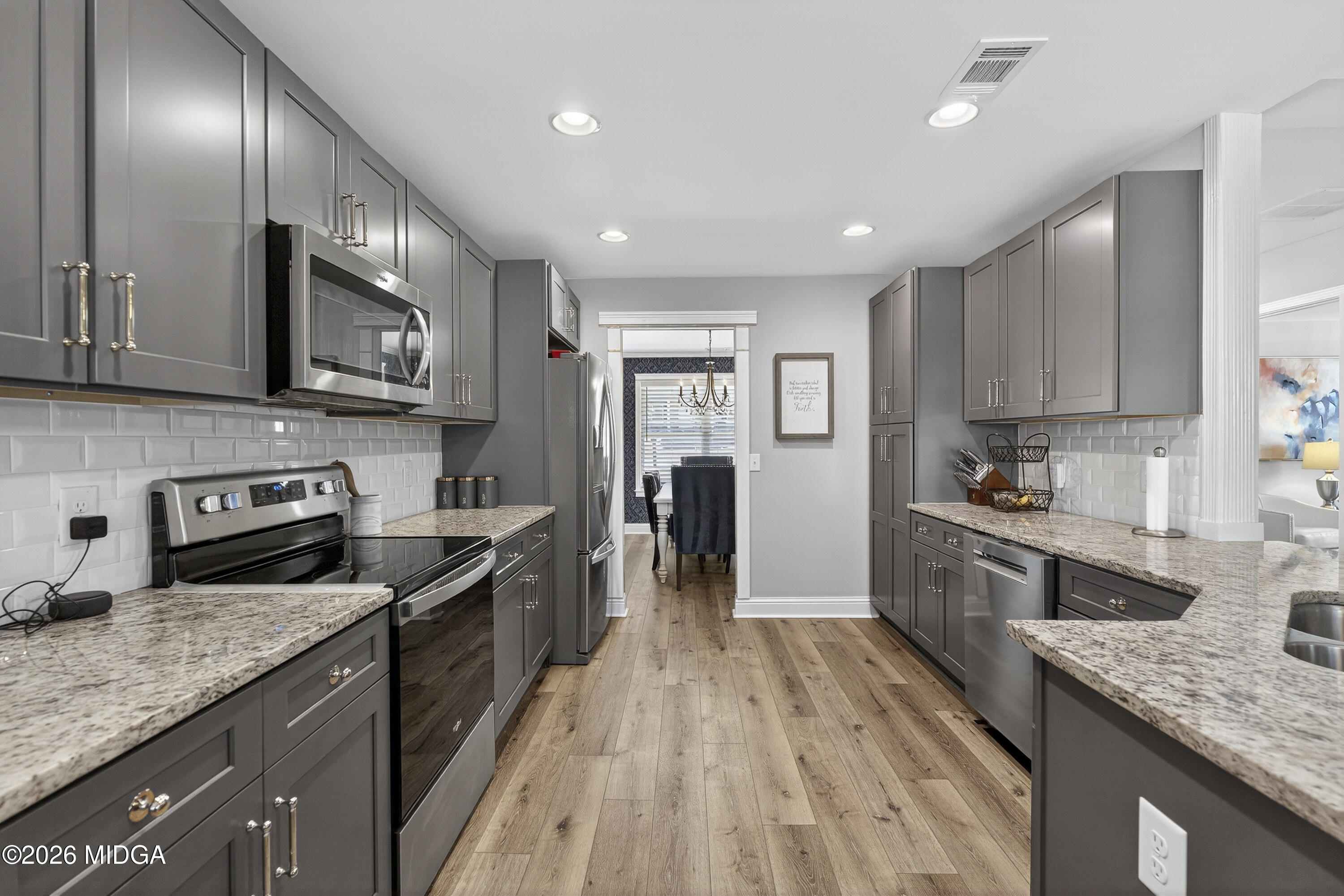 737 Springhill Drive Gray, GA 31032 - Photo 22 of 60 a kitchen with stainless steel appliances granite countertop wooden cabinets a sink dishwasher a stove and a refrigerator