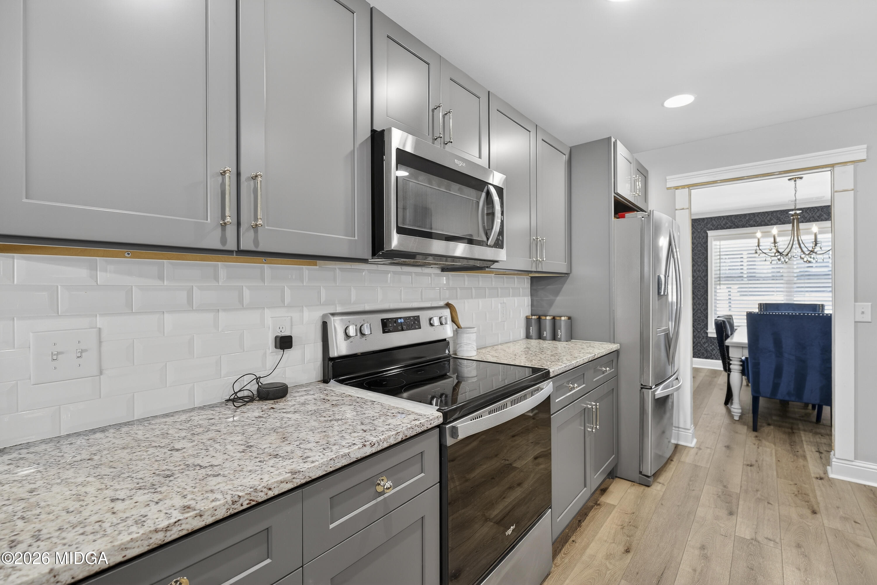 737 Springhill Drive Gray, GA 31032 - Photo 23 of 60 a kitchen with granite countertop a sink stainless steel appliances and cabinets