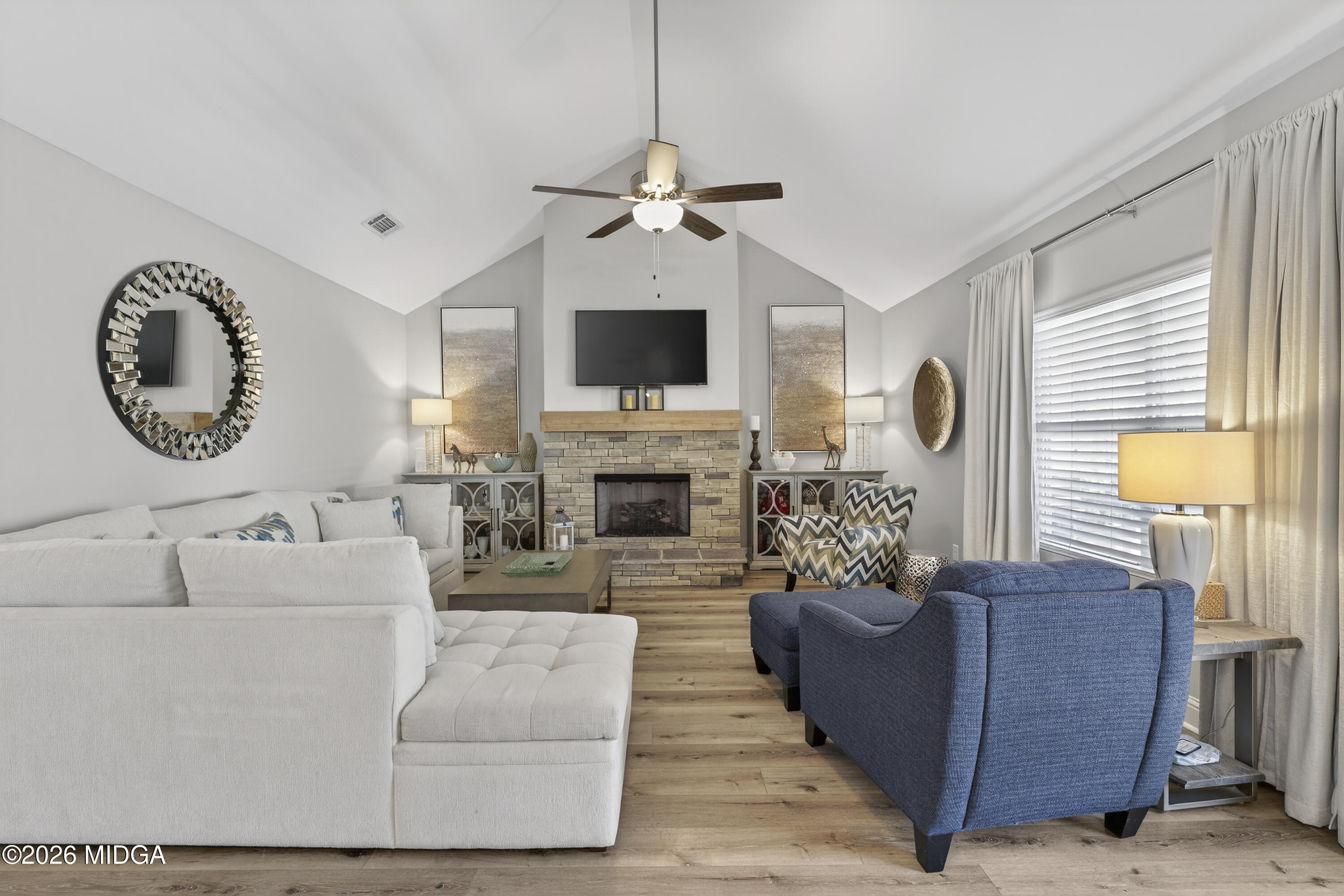737 Springhill Drive Gray, GA 31032 - Photo 29 of 60 a living room with furniture a fireplace and a flat screen tv