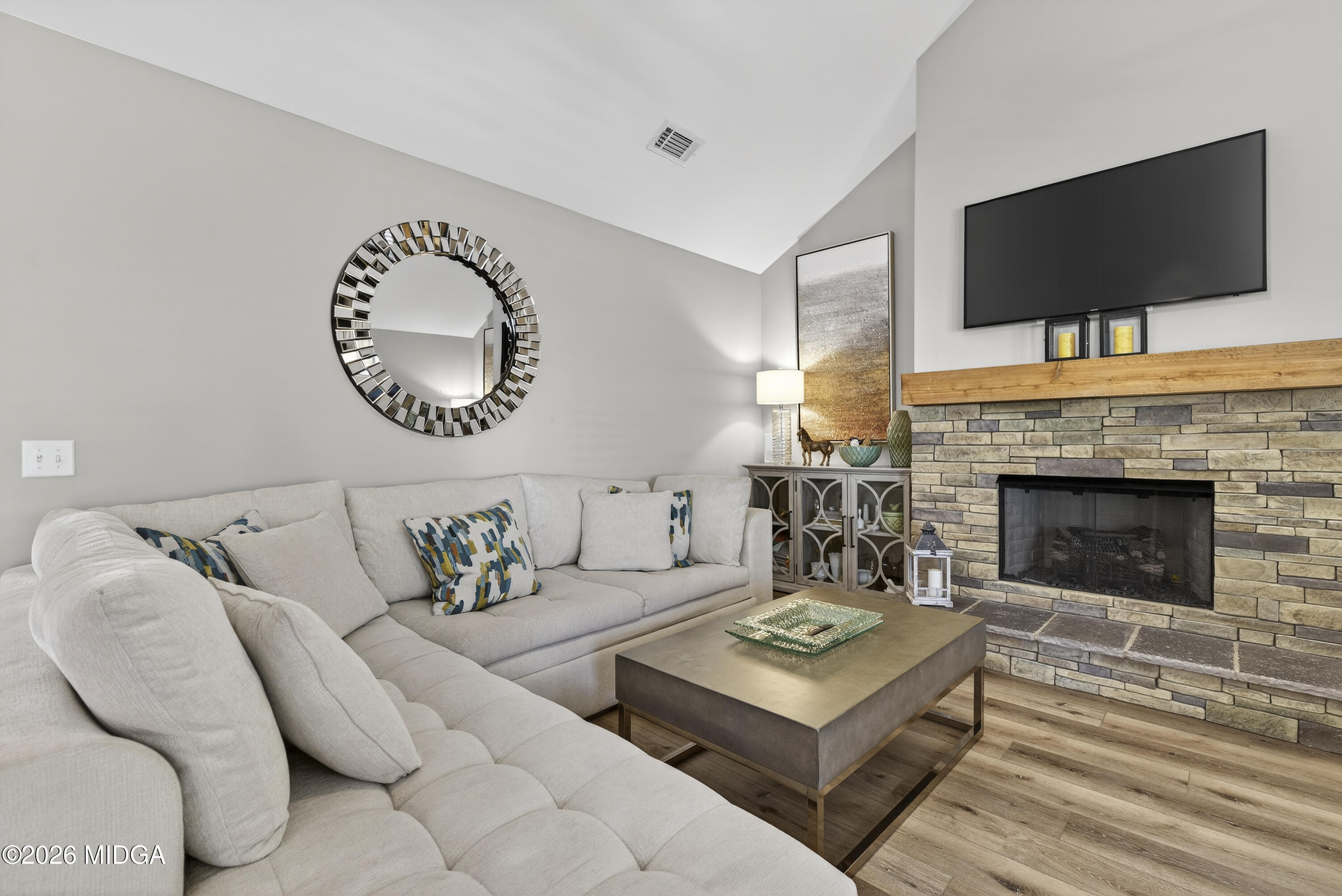 737 Springhill Drive Gray, GA 31032 - Photo 30 of 60 a living room with furniture a flat screen tv and a fireplace