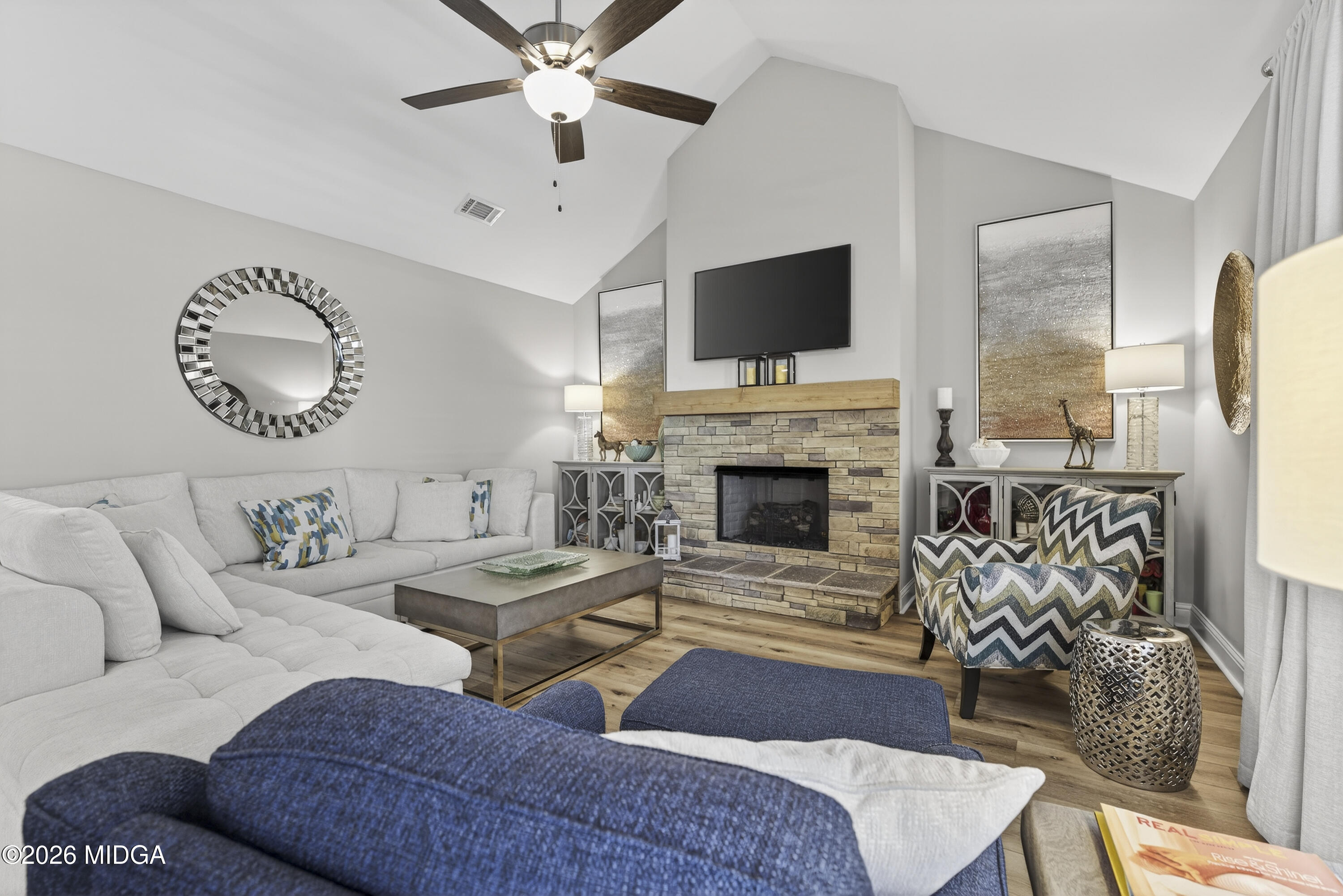 737 Springhill Drive Gray, GA 31032 - Photo 34 of 60 a living room with furniture a flat screen tv and a fireplace