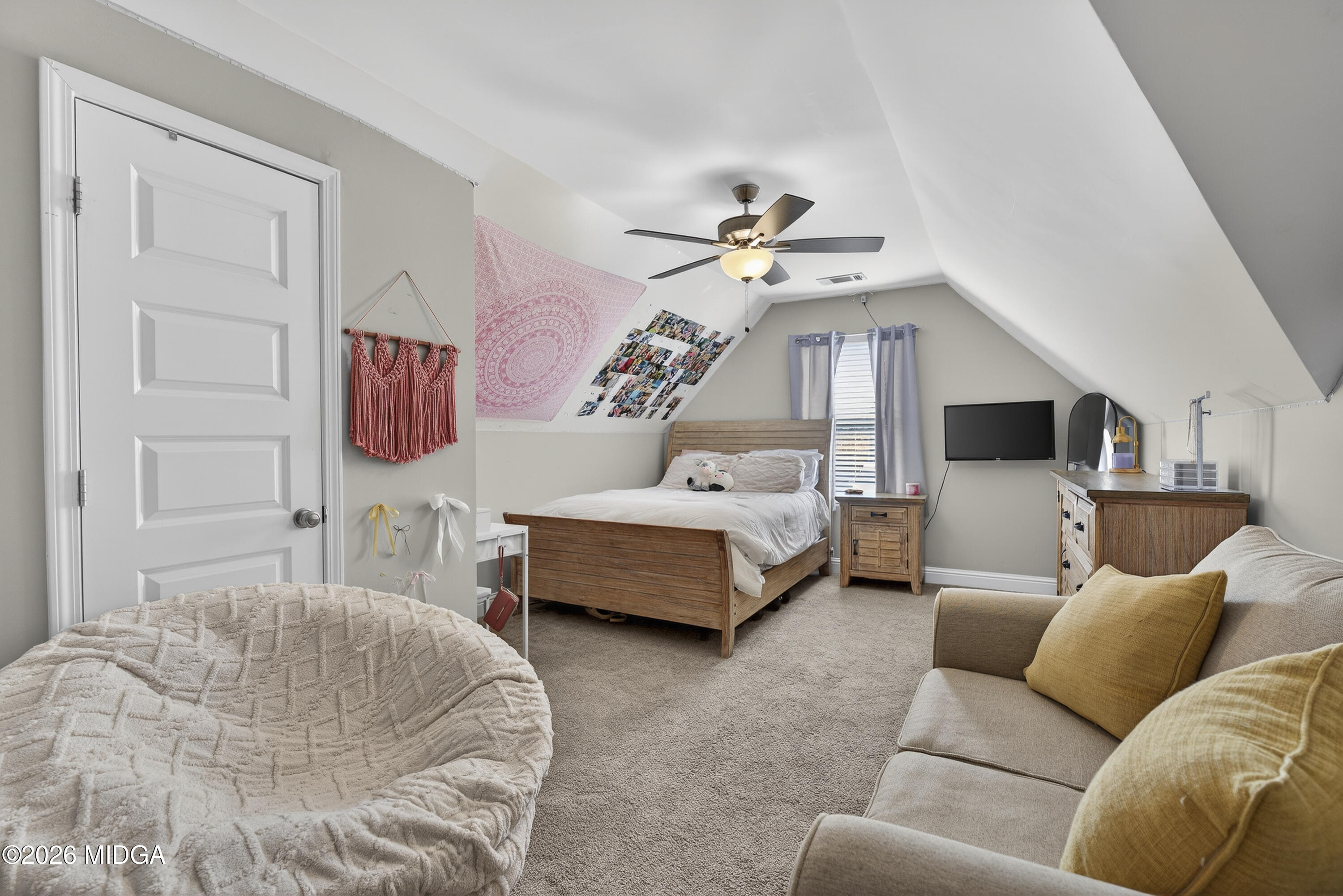 737 Springhill Drive Gray, GA 31032 - Photo 48 of 60 a spacious bedroom with a bed a couch and a chandelier