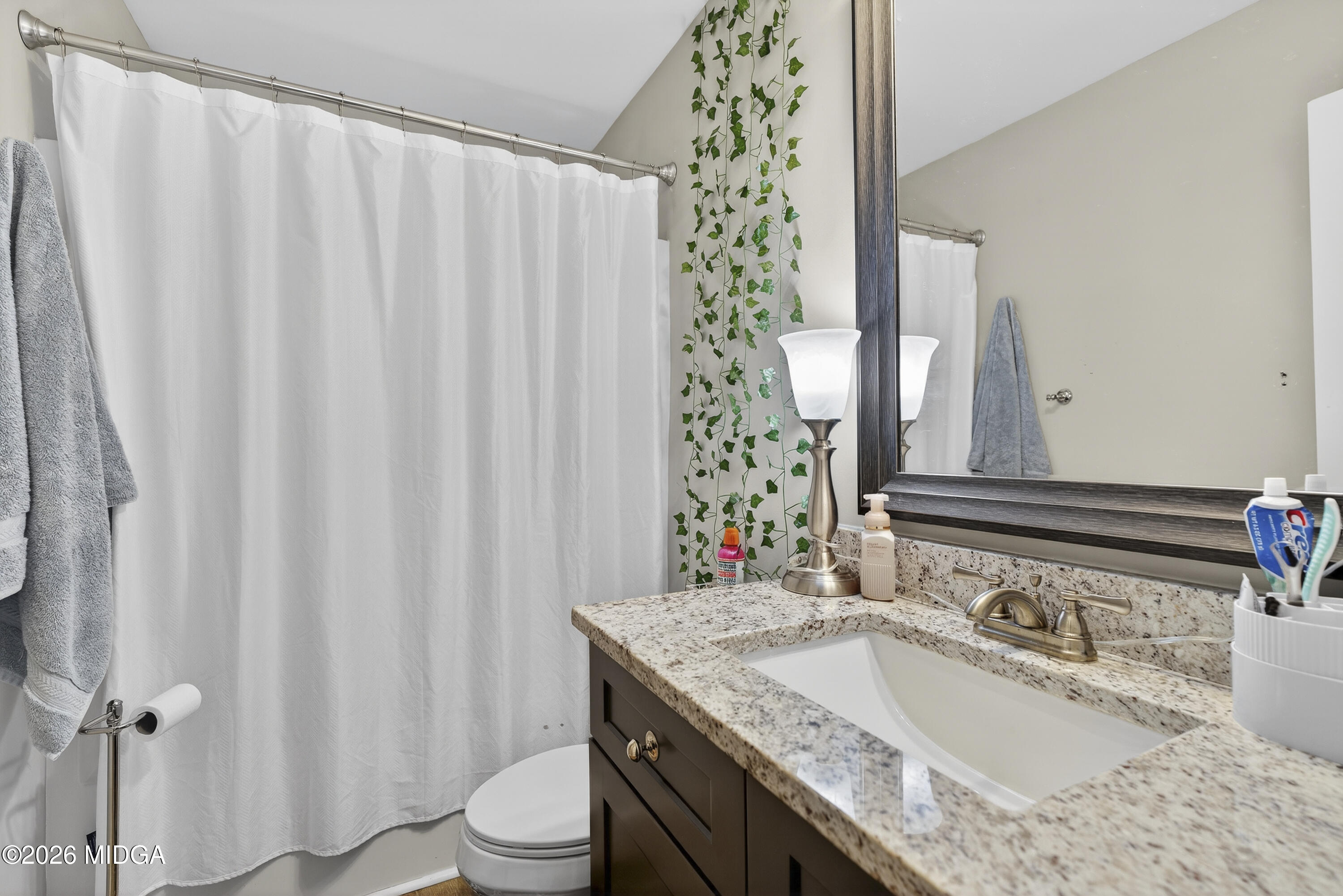 737 Springhill Drive Gray, GA 31032 - Photo 50 of 60 a bathroom with a granite countertop sink and a mirror