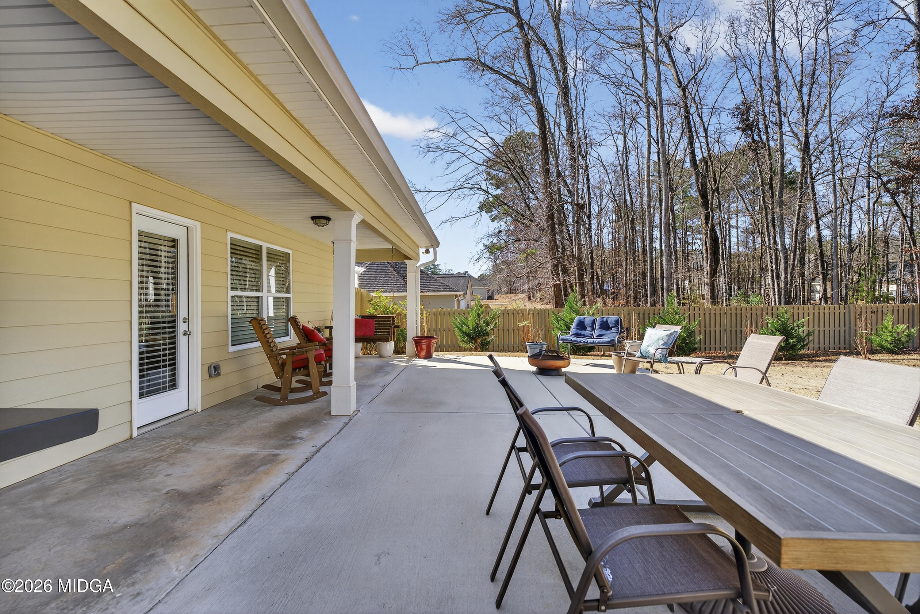 737 Springhill Drive Gray, GA 31032 - Photo 56 of 60 a view of a patio with table and chairs and floor to ceiling window