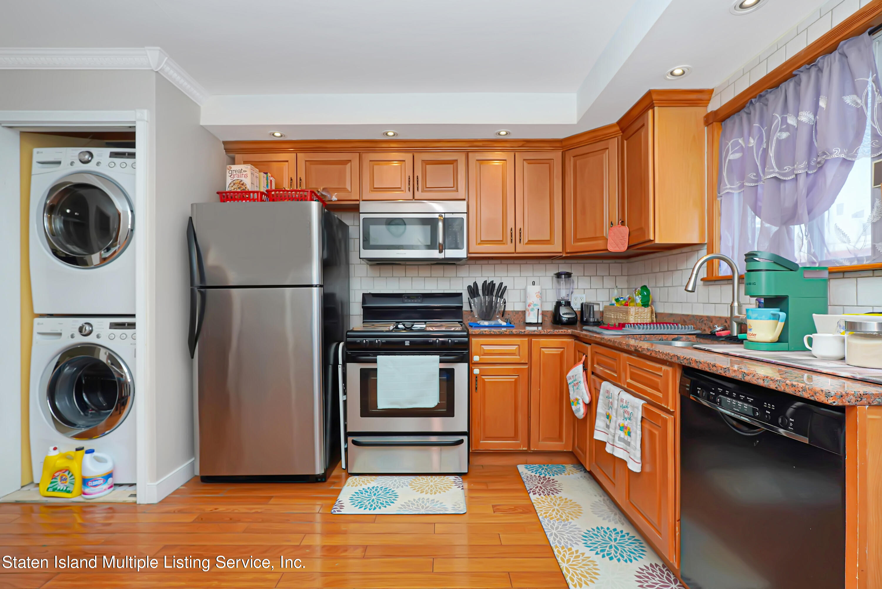 258 Edgewater Street Staten Island, NY 10305 - Photo 11 of 33 a kitchen with stainless steel appliances granite countertop a refrigerator and a stove top oven