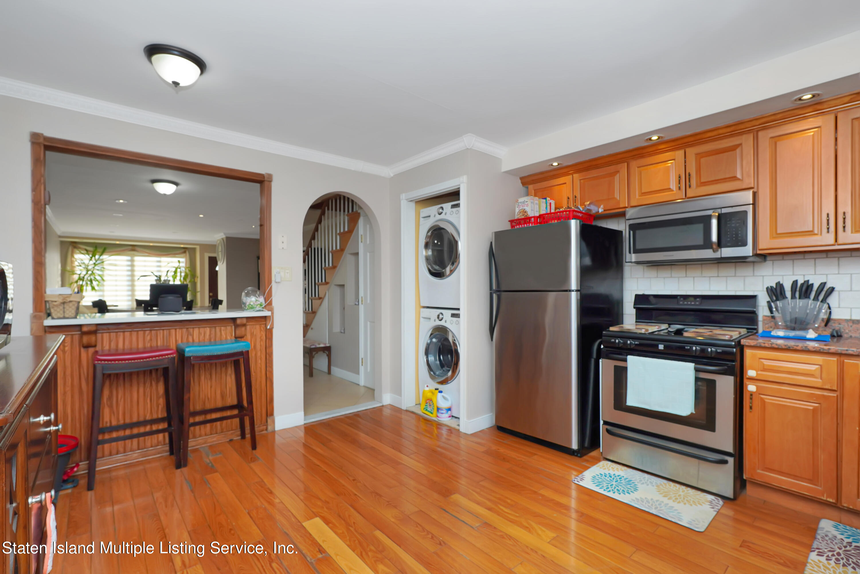 258 Edgewater Street Staten Island, NY 10305 - Photo 12 of 33 a kitchen with stainless steel appliances granite countertop a refrigerator a stove and a sink with granite countertops