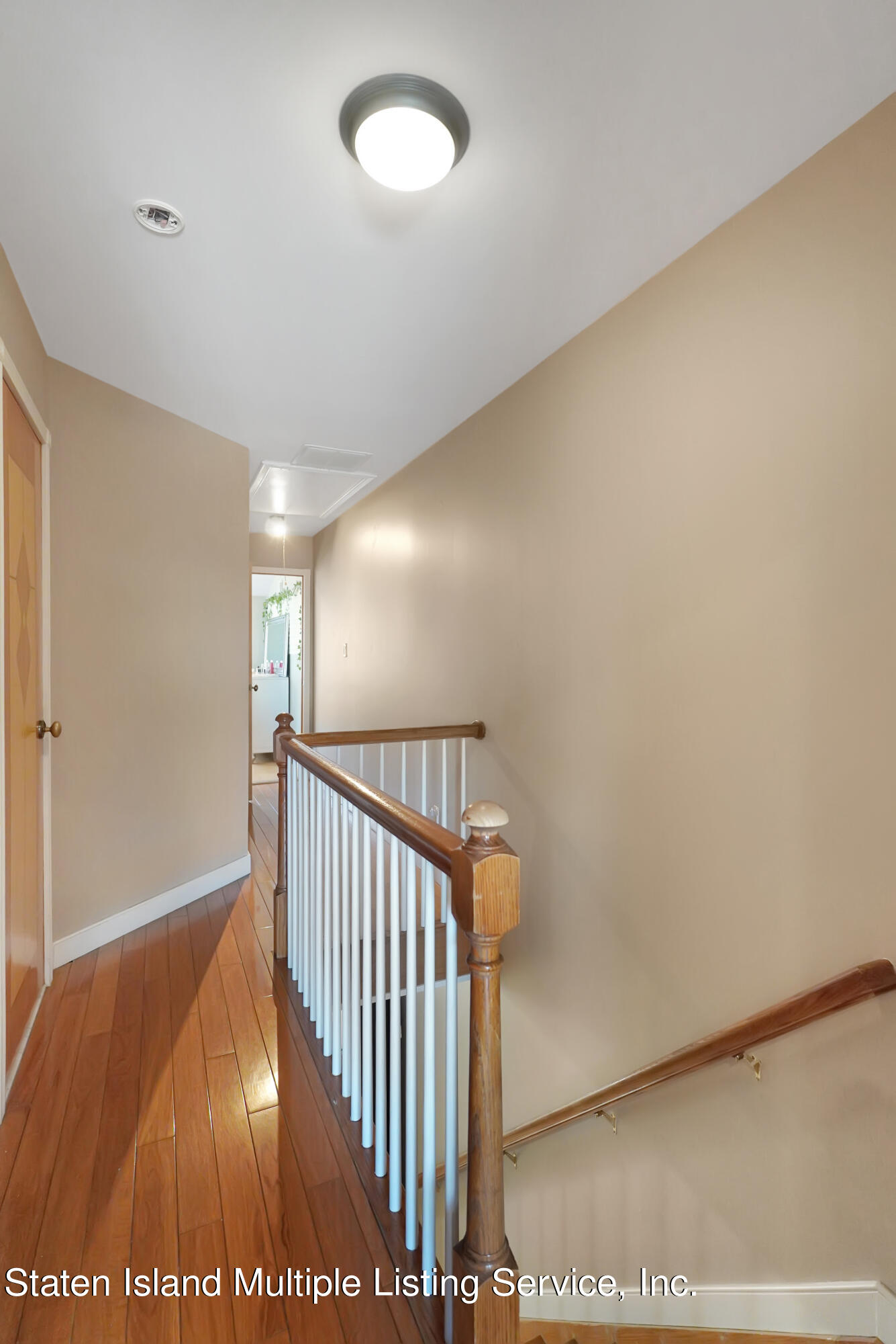 258 Edgewater Street Staten Island, NY 10305 - Photo 16 of 33 a view of a hallway with wooden floor