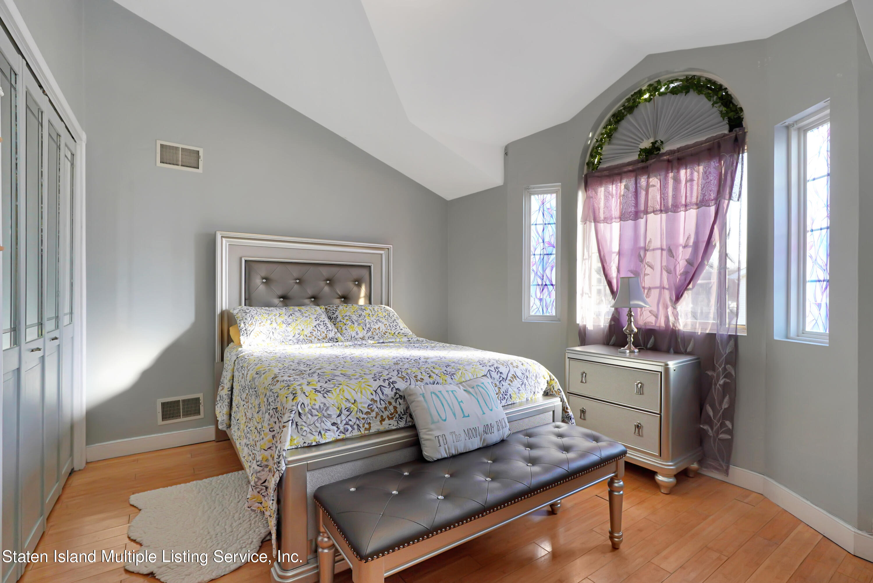 258 Edgewater Street Staten Island, NY 10305 - Photo 17 of 33 a bedroom with a bed window and mirror