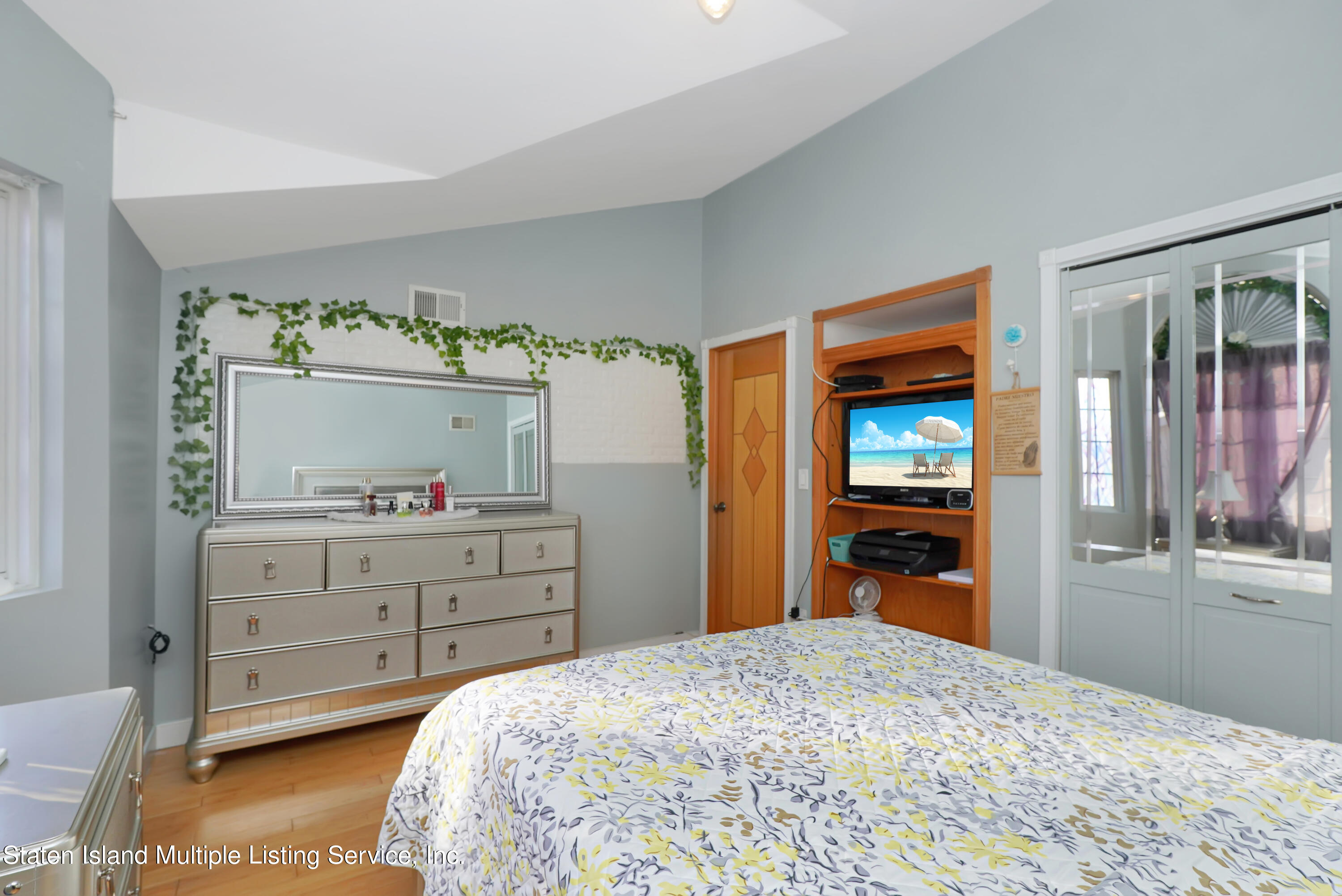258 Edgewater Street Staten Island, NY 10305 - Photo 19 of 33 a bedroom with a bed and wooden floor