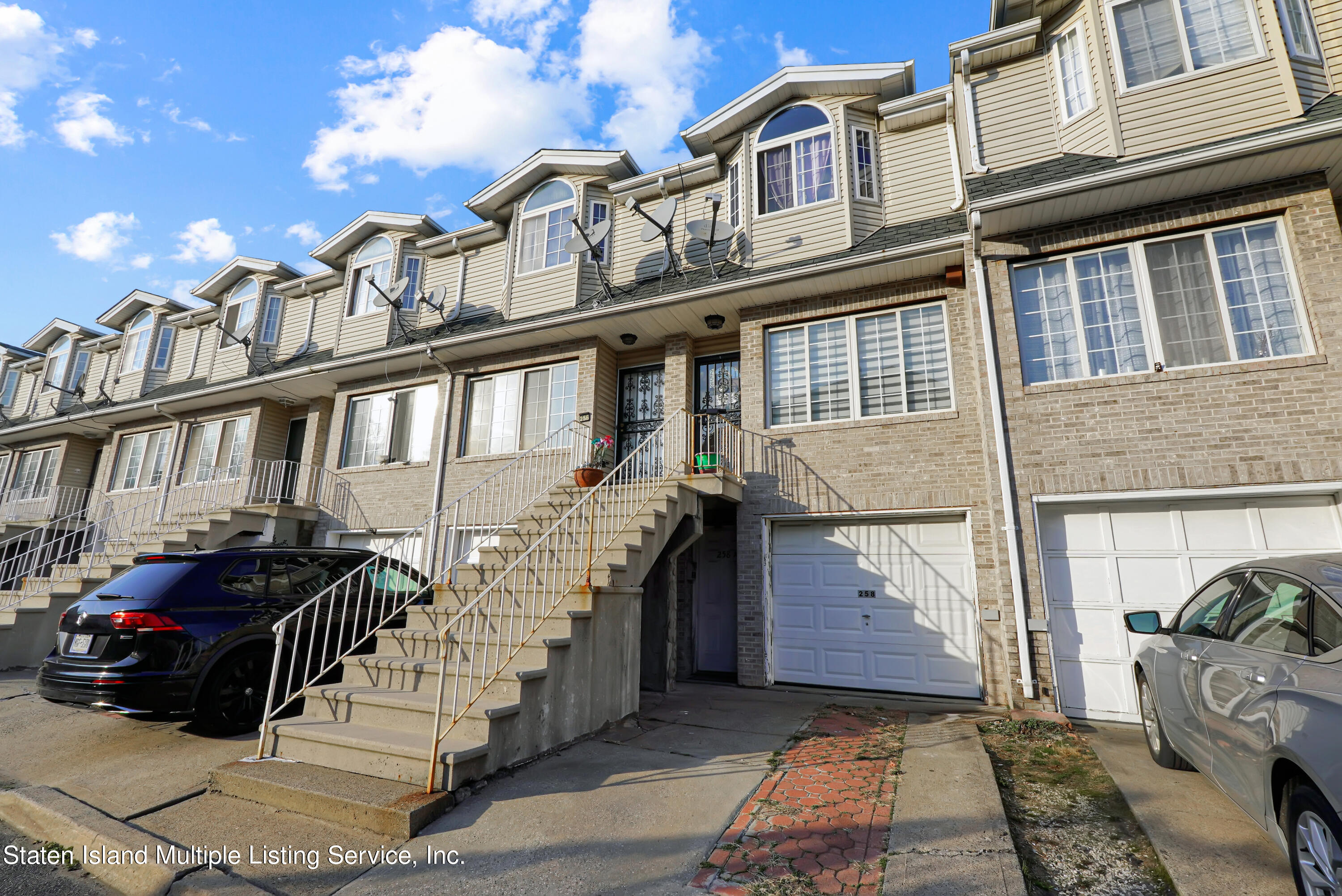 258 Edgewater Street Staten Island, NY 10305 - Photo 2 of 33 a front view of a house with a yard
