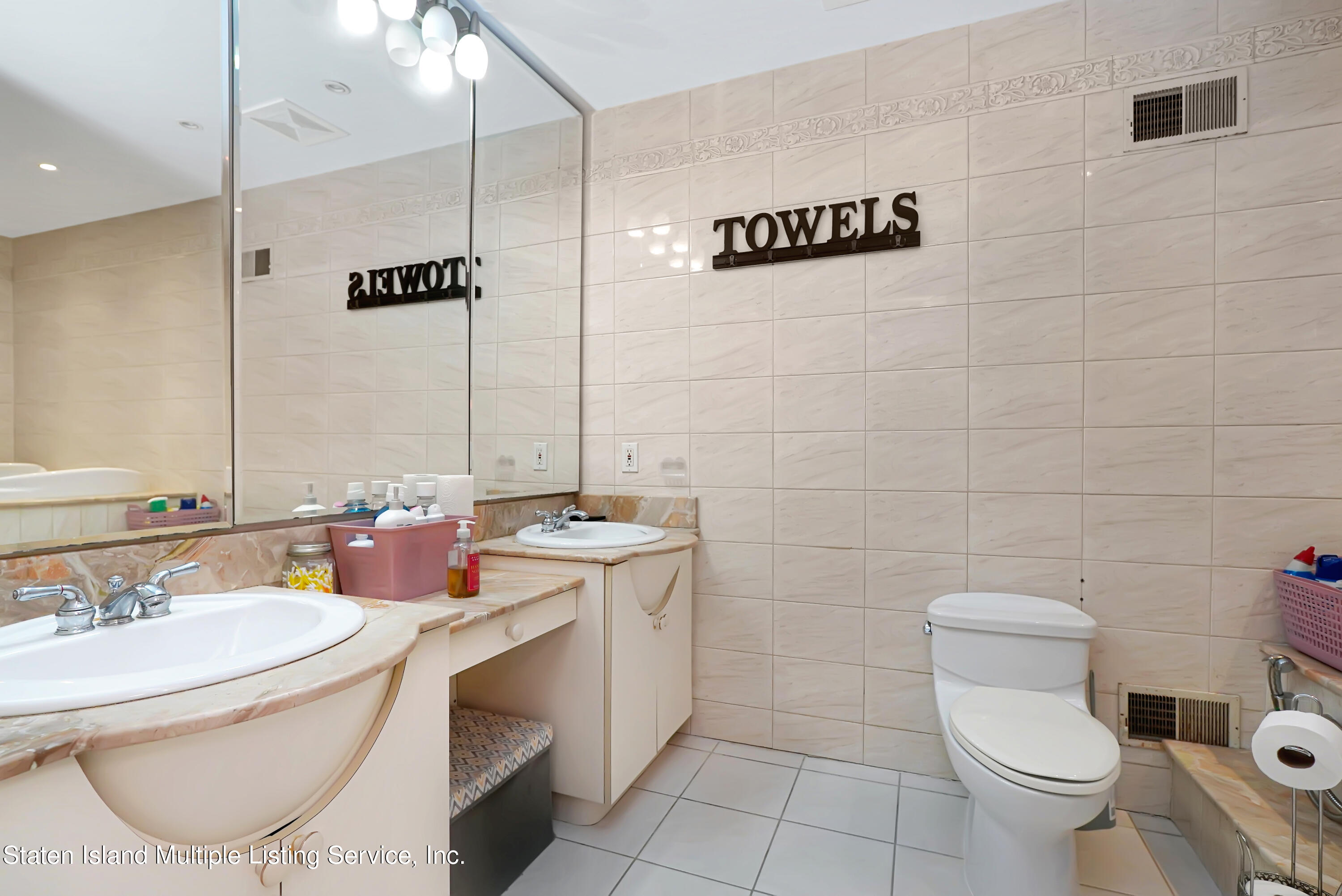 258 Edgewater Street Staten Island, NY 10305 - Photo 23 of 33 a bathroom with a granite countertop sink a mirror and a toilet
