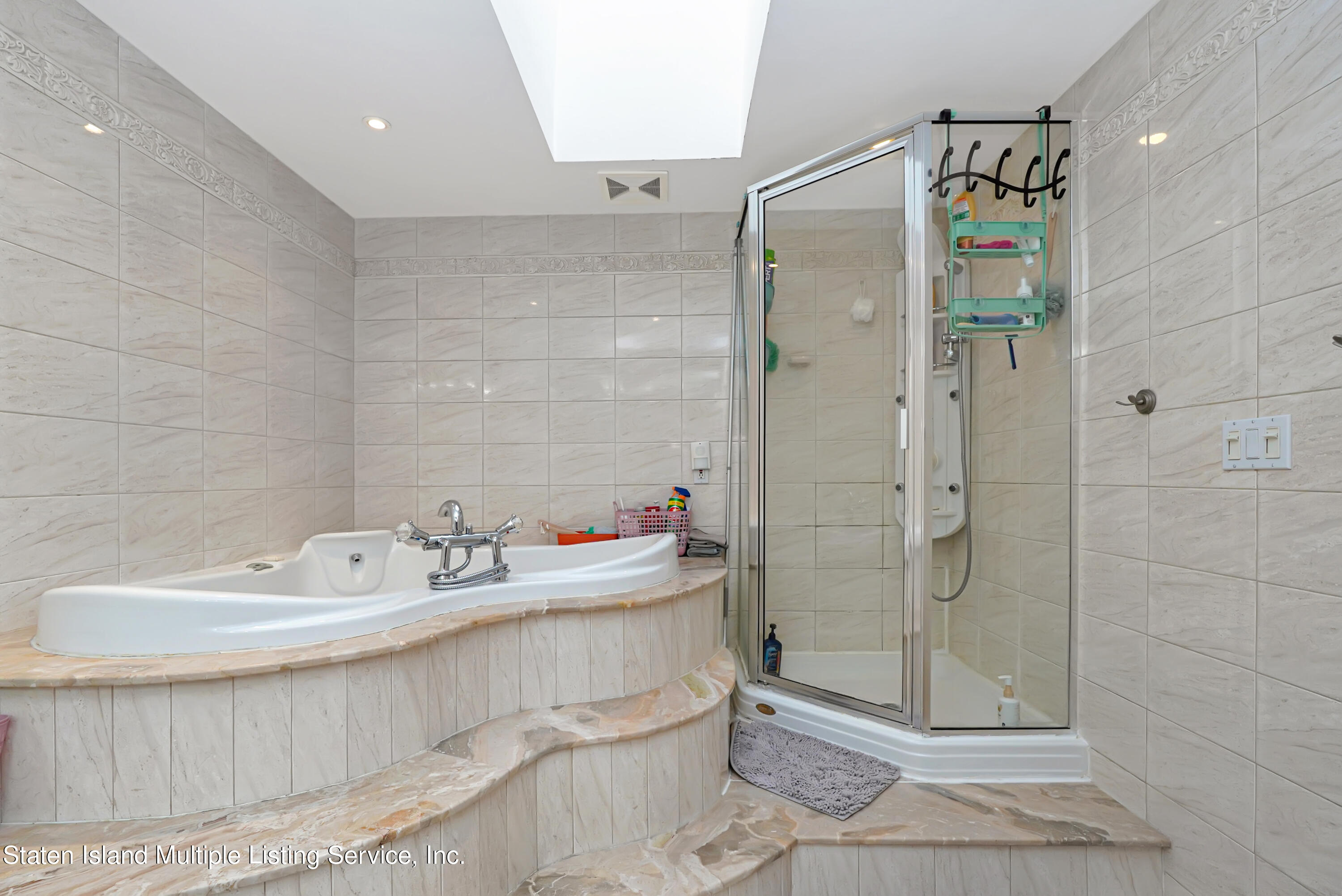 258 Edgewater Street Staten Island, NY 10305 - Photo 24 of 33 a bathroom with a shower sink and mirror