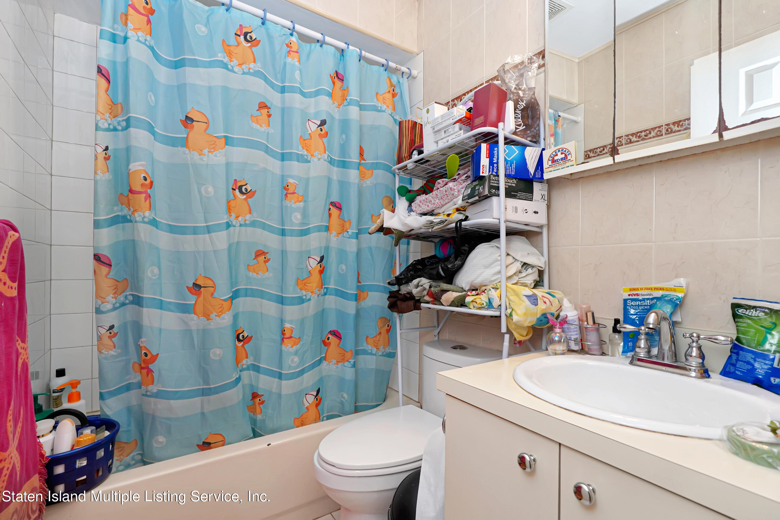 258 Edgewater Street Staten Island, NY 10305 - Photo 25 of 33 a utility room with lots of clutter and cabinets