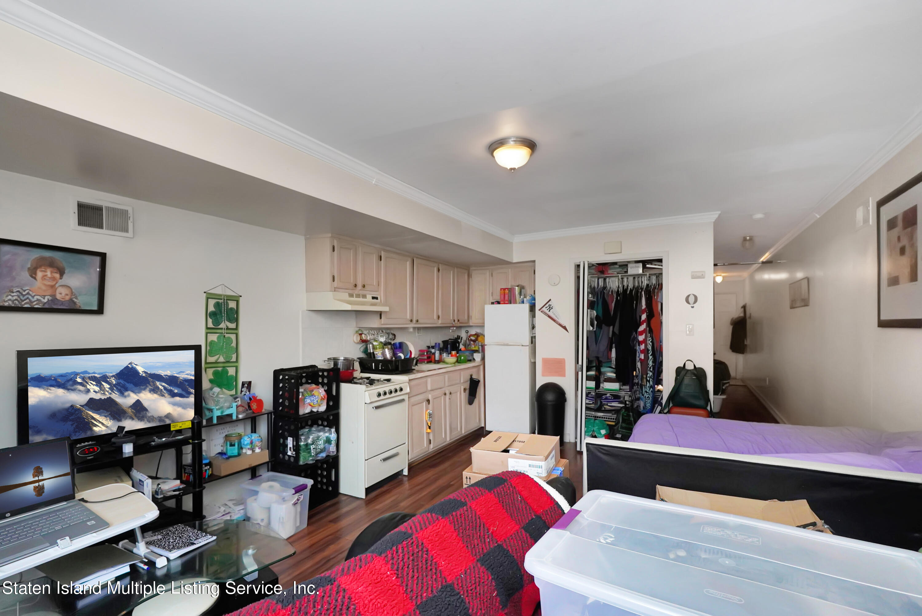 258 Edgewater Street Staten Island, NY 10305 - Photo 28 of 33 a living room with furniture and a flat screen tv