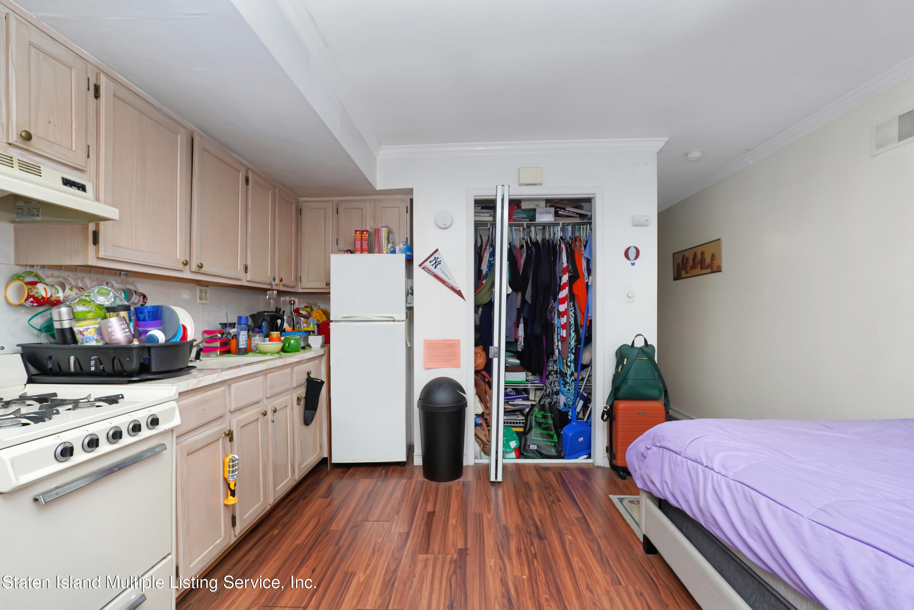 258 Edgewater Street Staten Island, NY 10305 - Photo 29 of 33 a kitchen that has a lot of white cabinets and wooden floor