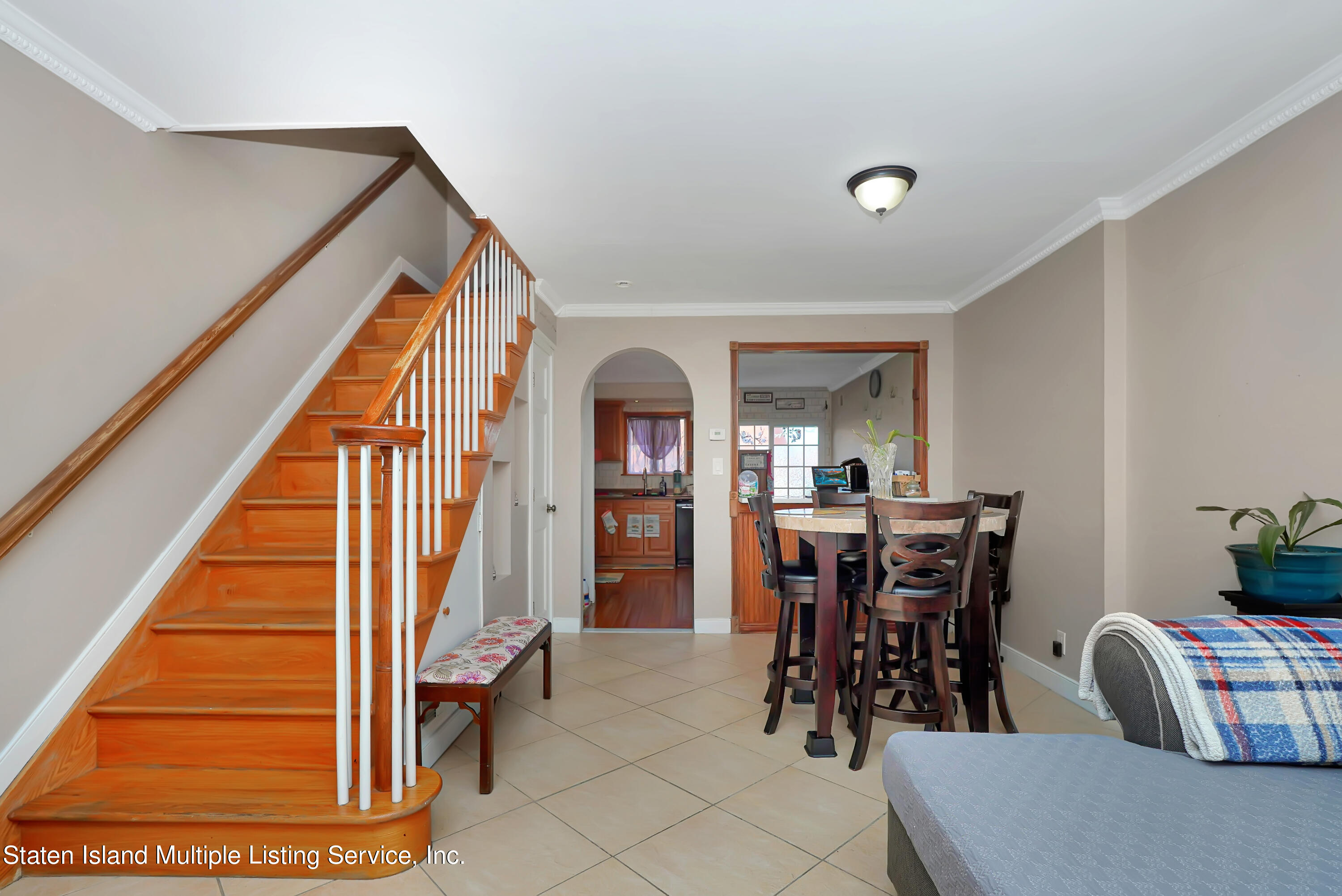 258 Edgewater Street Staten Island, NY 10305 - Photo 7 of 33 a view of dining room and livingroom with furniture wooden floor and a rug
