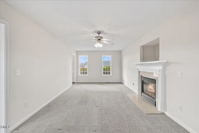 a view of a hallway with wooden floor and entryway