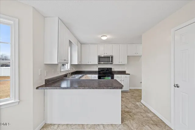 a bathroom with a tub sink shower and mirror