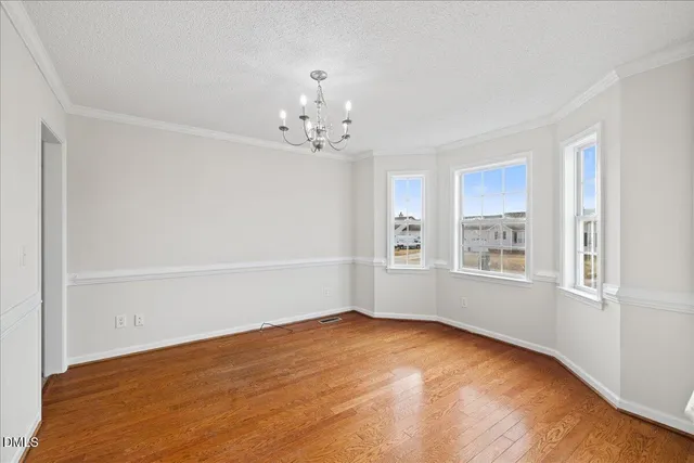 a view of a house with wooden fence