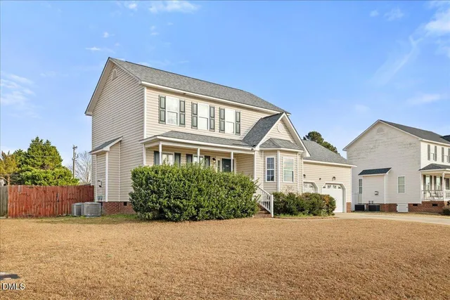 an empty room with windows and fireplace