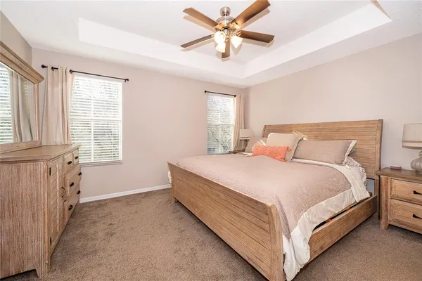 a spacious bedroom with a bed and a chandelier