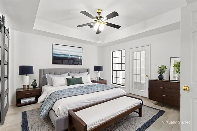 a bedroom with a large bed and a chandelier