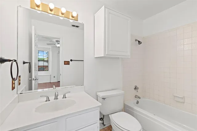 a bedroom with a bed a couch and a window