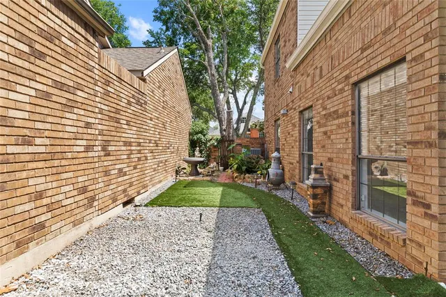 a pathway of a house with a yard