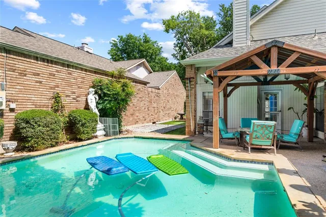 a view of a house with a yard patio and a slide