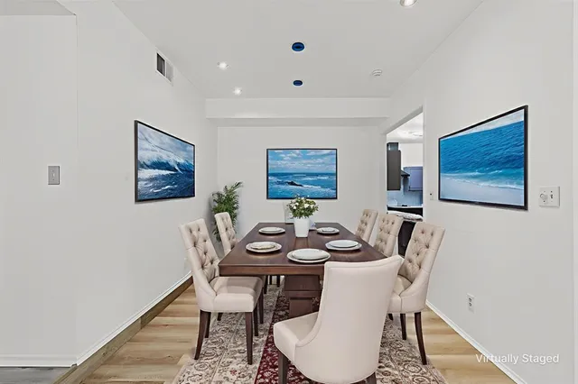 a dining room with furniture a rug and wooden floor