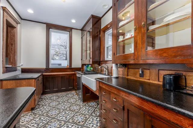 a kitchen with granite countertop a stove top oven microwave and cabinets