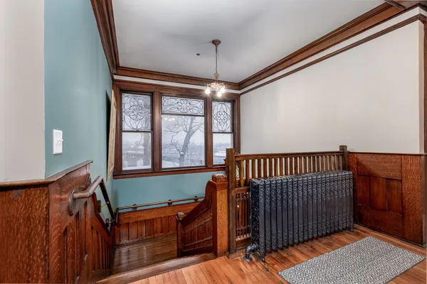 a bedroom with bed and wooden floor