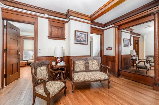a bedroom with furniture and wooden floor