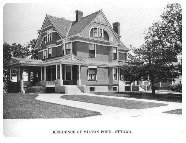a front view of a building with a garden
