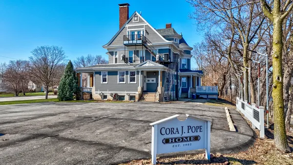 a large kitchen with stainless steel appliances a large counter top a stove a sink and a window